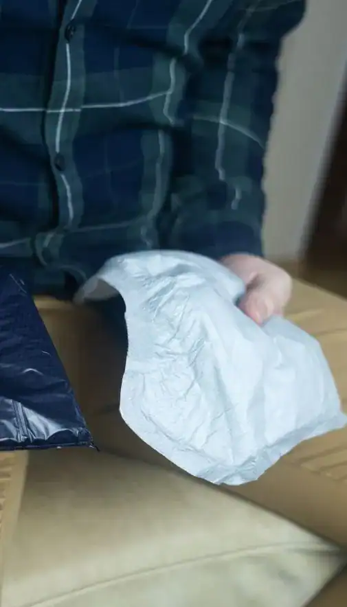 Image of man holding incontinence pads as part of overactive bladder treatment Wolverhampton